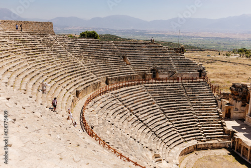 Old dilapidated architecture of Turkey. Ruins of an ancient city with huge amphitheater. Journey to the old city. Mountain landscape. Ancient city of Hierapolis, Pamukkale, Türkiye - July 29, 2023