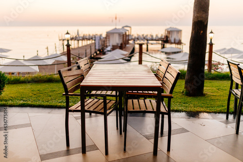 Fototapeta Naklejka Na Ścianę i Meble -  View of the sea at dawn from the beach of a cozy resort on the ocean. Sunset in the Mediterranean sea, Antalya, Türkiye. Picturesque sunset in Kemer, Turkey. Beautiful oceanfront resort at sunset