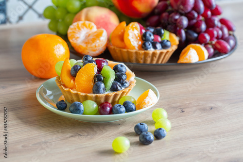 cupcakes with fruits on wooden table on kitchen