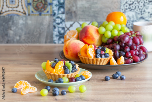 cupcakes with fruits on wooden table on kitchen