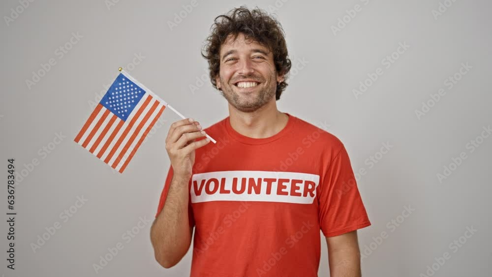 Young hispanic man activist holding united states flag over isolated white background Young hispanic man activist holding united states flag over isolated white background