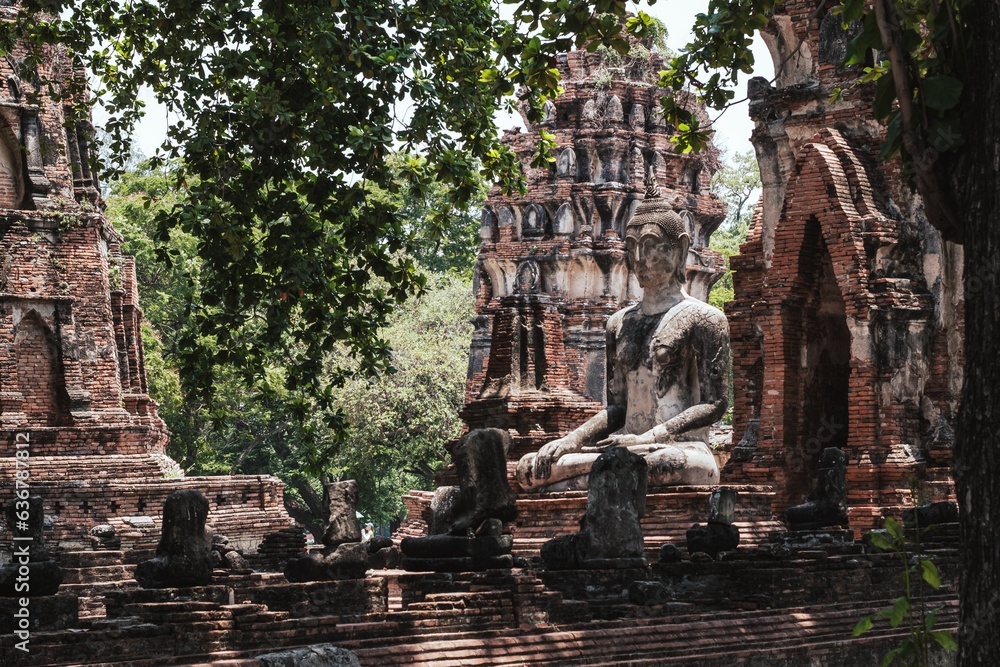 Ruins of Buddha statues and pagoda in Wat Mahathat, the old Thai temple, Thailand.