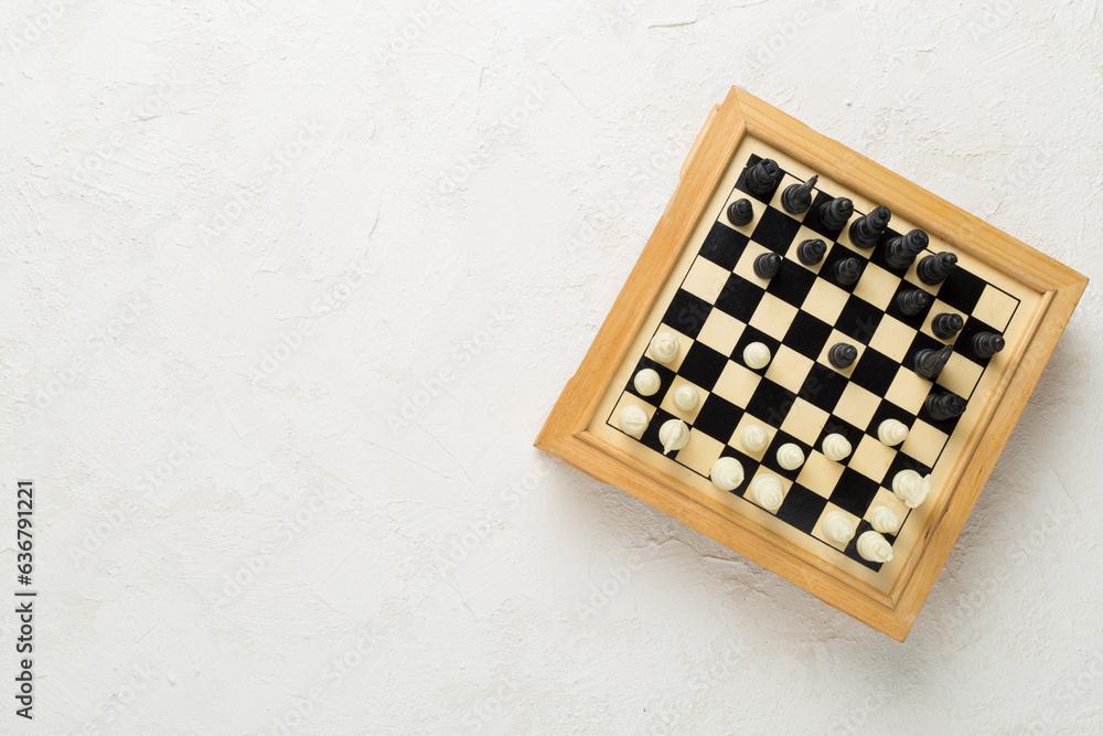 Wooden chess on concrete background, top view Wooden chess on concrete background, top view