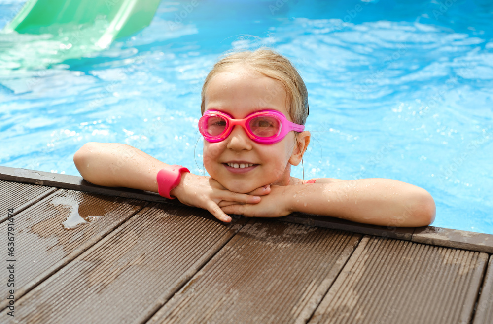 Happy child in outdoor swimming pool. Preschool girl enjoying summer time swimming. Kid having fun near water, activities for rest and health on vacations On the edge of pool. Getting ready to dive