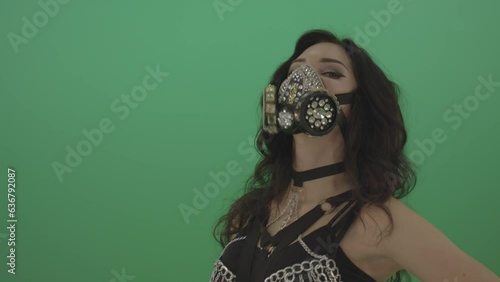 Black hair girl in diamond fashion mask moving head on chromakey photo