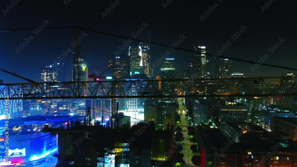 Aerial Panning Shot Of Illuminated Towers In City Against Sky At Night - Los Angeles, California Aerial Panning Shot Of Illuminated Towers In City Against Sky At Night - Los Angeles, California