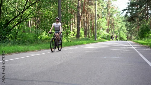 Wallpaper Mural Pensive dreamful happy woman 40s wearing casual jeans short and tshirt riding bicycle bike in city summer park outdoors, look aside. People active urban healthy lifestyle cycling concept Torontodigital.ca