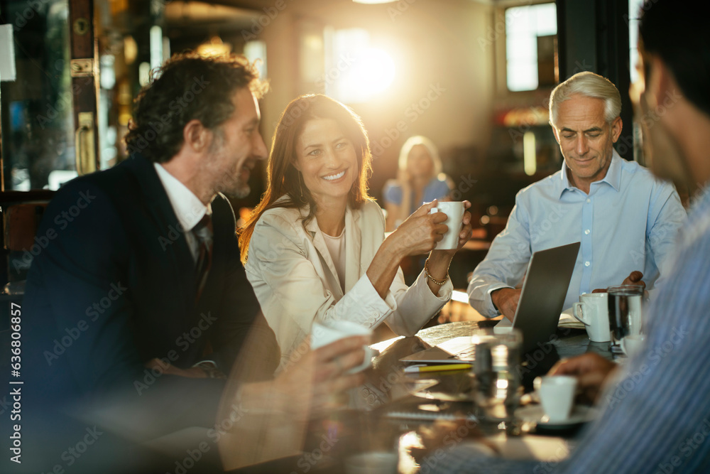 © Marko Geber - Group of business people having a meeting in a cafe bar