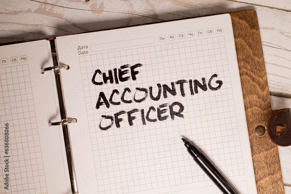 Φωτογραφία On financial reports lies a calculator, a pen and a sticker with the inscription - CHIEF ACCOUNTING OFFICER