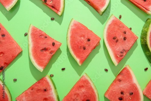 Composition with pieces of fresh ripe watermelon on green background