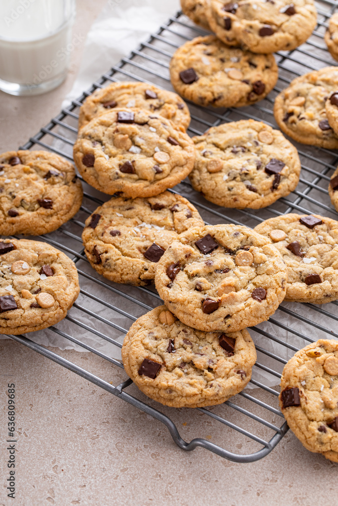 Chocolate chip cookies on a cooling rack with flaky salt served with milk Chocolate chip cookies on a cooling rack with flaky salt served with milk