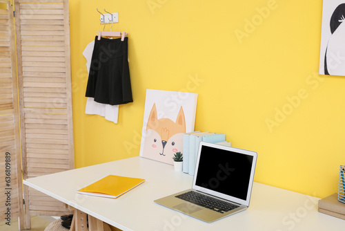 Interior of modern room with workplace and stylish school uniform © Pixel-Shot