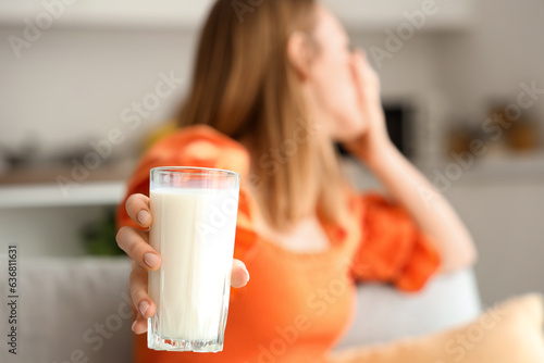 Canvas Print Young woman with lactose intolerance at home