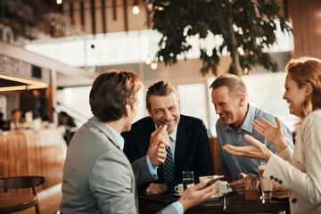 Group of business people having coffee and talking in a cafe decorated for the christmas and new year holidays