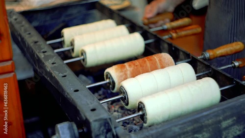 Kurtoskalacs (Kürtőskalács) or Trdelník (traditional street food from central Europe and Hungary) is frying.