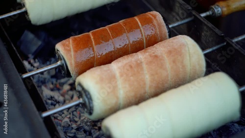 Kurtoskalacs (Kürtőskalács) or Trdelník (traditional street food from central Europe and Hungary) is frying.