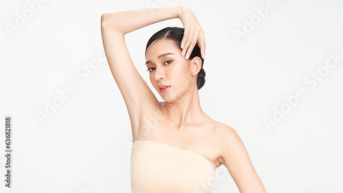 Beautiful Young woman lifting hands up to show off clean and hygienic armpits or underarms on white background, Smooth armpit cleanliness and protection concept