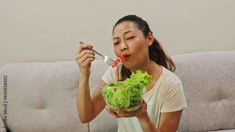 Cheerful happy Asian woman lifestyle eating salad holding bowl of tomatoes, bell peppers, fresh vegetables and measuring tape, wants to lose weight, stay slim and healthy. Cheerful happy Asian woman lifestyle eating salad holding bowl of tomatoes, bell peppers, fresh vegetables and measuring tape, wants to lose weight, stay slim and healthy.