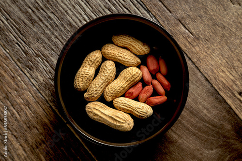 Peanuts with nutshell on a bowl, studio shot