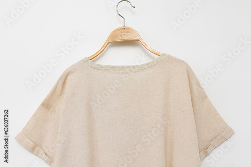 Linen clothes hanger isolated on white © Pornpawit