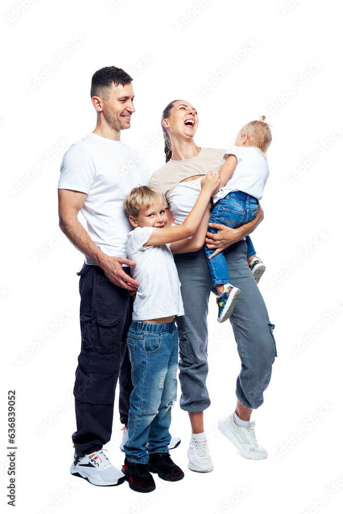 Happy family with children stand in full growth. Laughing mom, dad, little son and daughter in white t-shirts and jeans are hugging. Love and tenderness. Full height. Isolated on white background. 