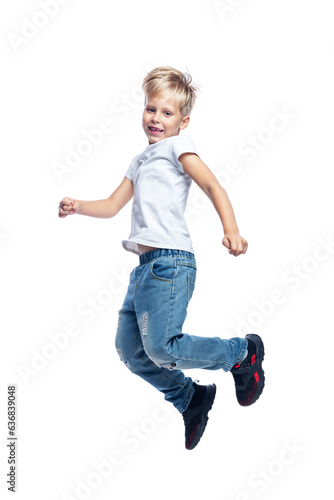 Laughing boy jumping. Blond guy in a white T-shirt and jeans. Energy and activity. Full height. Isolated on white background. Vertical.