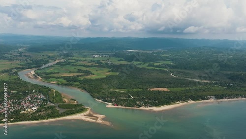 The river flows into the sea and the beach. Tropical landscape. Sipalay, Negros, Philippines. photo