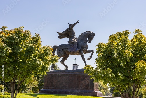 Tashkent, Uzbekistan - August 15, 2023: Monument to Amir Timur on the central square with the complex - "Hotel Uzbekistan", "Fund Forum" and "Tashkent Chimes". Is a visiting card of Uzbekistan
