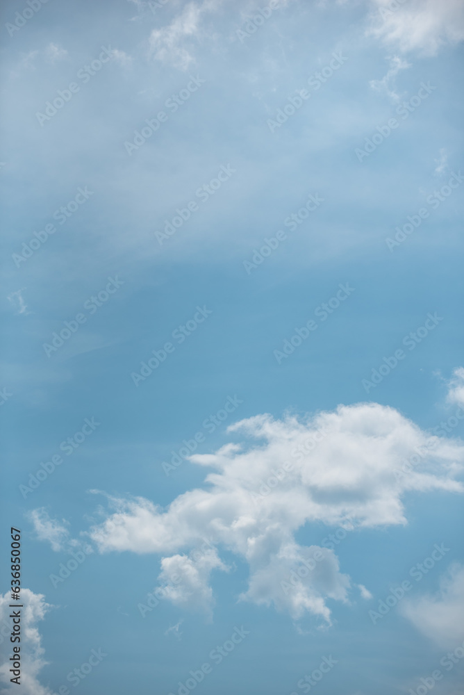 white clouds in the sky against a clear day. white clouds in the sky against a clear day.