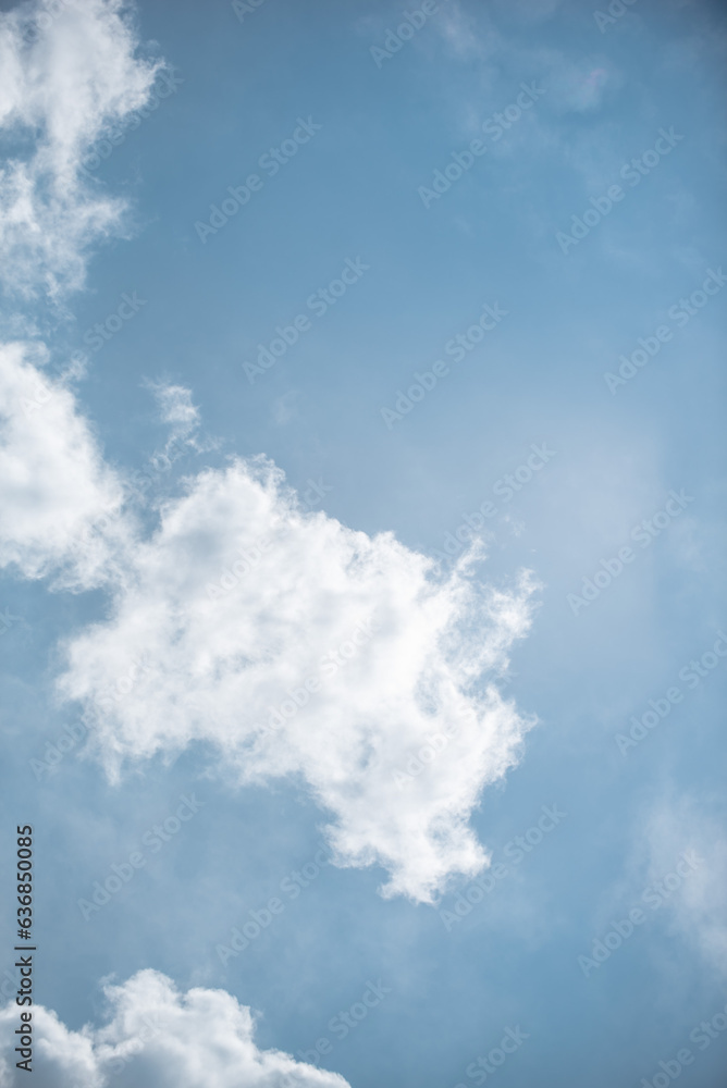 white clouds in the sky against a clear day. white clouds in the sky against a clear day.
