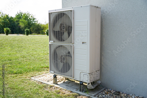 Obraz na płótnie Powerful air conditioning or heat pump outdoor unit with two fans, eco green energy house of future concept w salonie