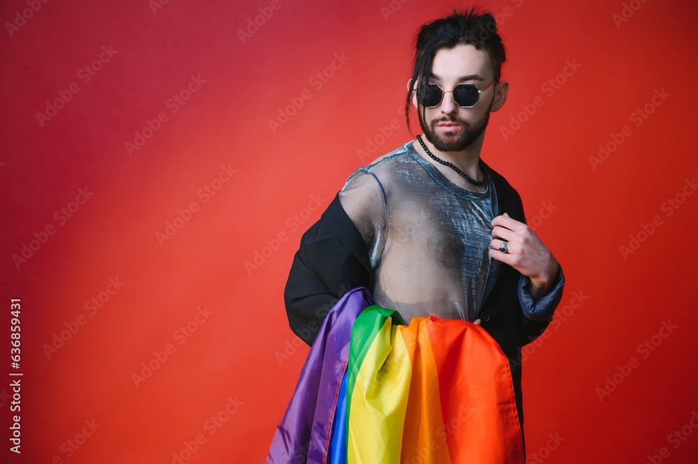 Youth transgender LGBT with Rainbow flag on shoulder isolated color background. gender expression pride and equality concept. Youth transgender LGBT with Rainbow flag on shoulder isolated color background. gender expression pride and equality concept.