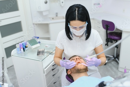 Young man at the dentist. Dental care  taking care of teeth. Picture with copy space for background.