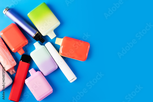vape, ecigarette, disposable liquid vaporizers on a blue background, copy space