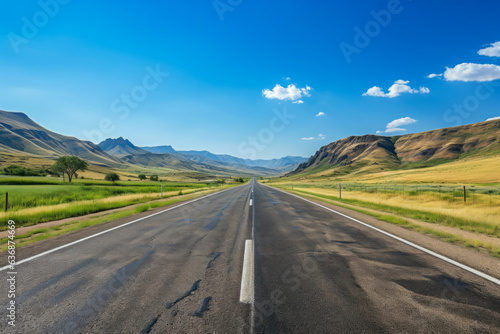 Straight very long asphalt road in a Beautiful mountain landscape with a blue sky in the background. good business concept for life and success.