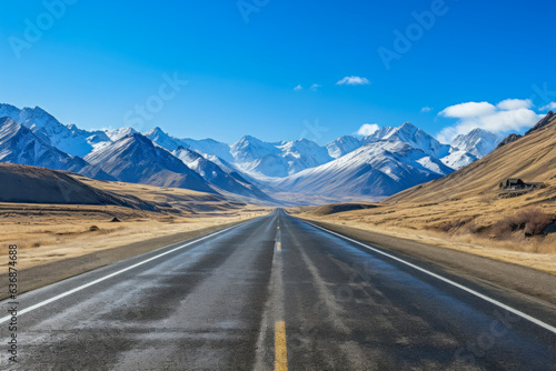 Straight very long asphalt road in a Beautiful winter mountain landscape with a blue sky in the background. good business concept for life and success.