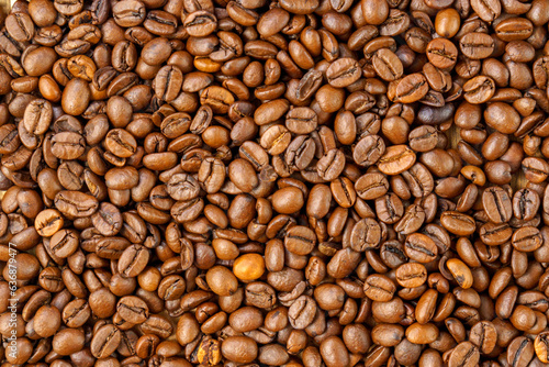 Roasted coffee bean. Masses of falling coffee beans close up. Texture
