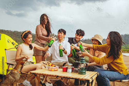 Meeting for fun vacation trips camping trips natural places : Happy group male and female friends singing songs and drinking beer having fun on vacation travel camping holiday trips natural fields.