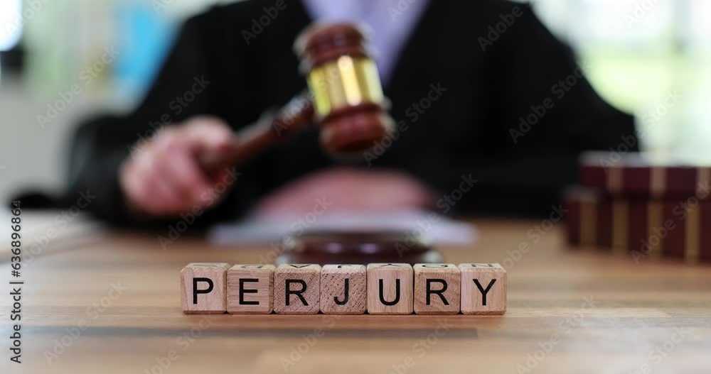 Word Perjury made of wooden blocks against judge knocking wooden gavel Word Perjury made of wooden blocks against judge knocking wooden gavel