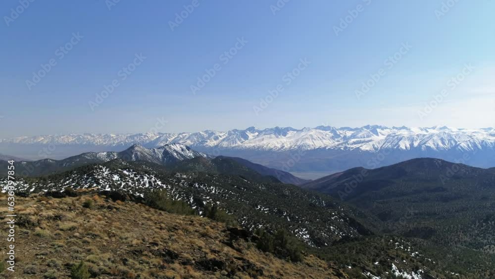 Aerial Shot Of Scenic Snowcapped Mountains Against Sky, Drone Flying Backward Over Natural Landscape - Bishop, California Aerial Shot Of Scenic Snowcapped Mountains Against Sky, Drone Flying Backward Over Natural Landscape - Bishop, California