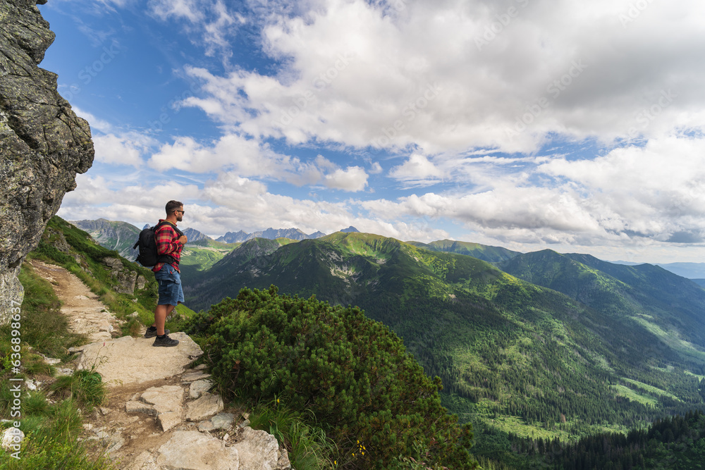 A man in a red shirt, a traveler in the Tatra mountains on a summer day. A man in a red shirt, a traveler in the Tatra mountains on a summer day.