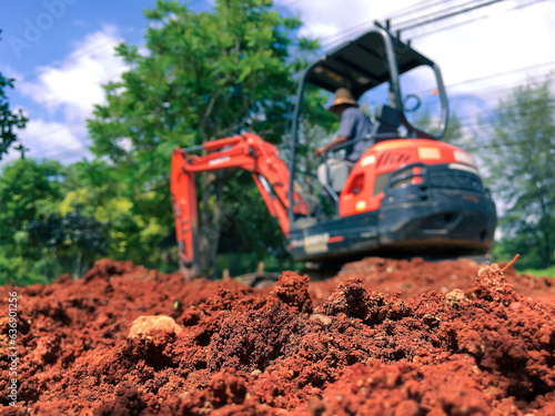 Soil close up blurred backhoe to renovate the site in preparation for pouring the concrete slab