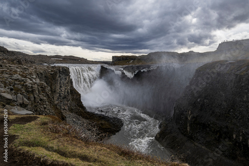 The most powerful waterfall in europe, the dettifoss on iceland in summer under a dramatic sky with dark storm clouds -areal view
