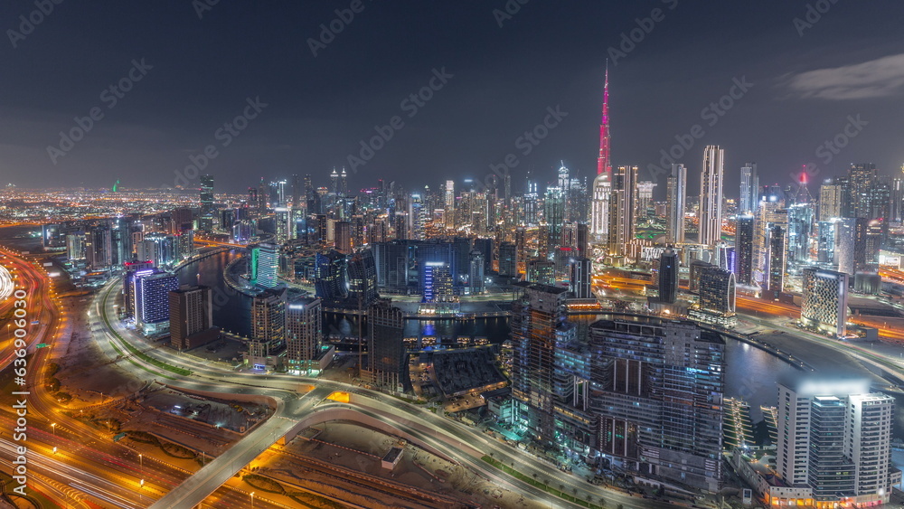 Skyline with modern architecture of Dubai business bay towers day to night timelapse. Aerial view