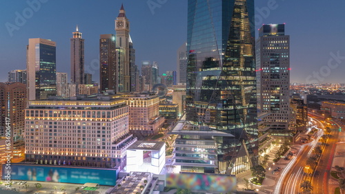 Dubai International Financial district aerial day to night timelapse. Panoramic view of business and financial office towers.