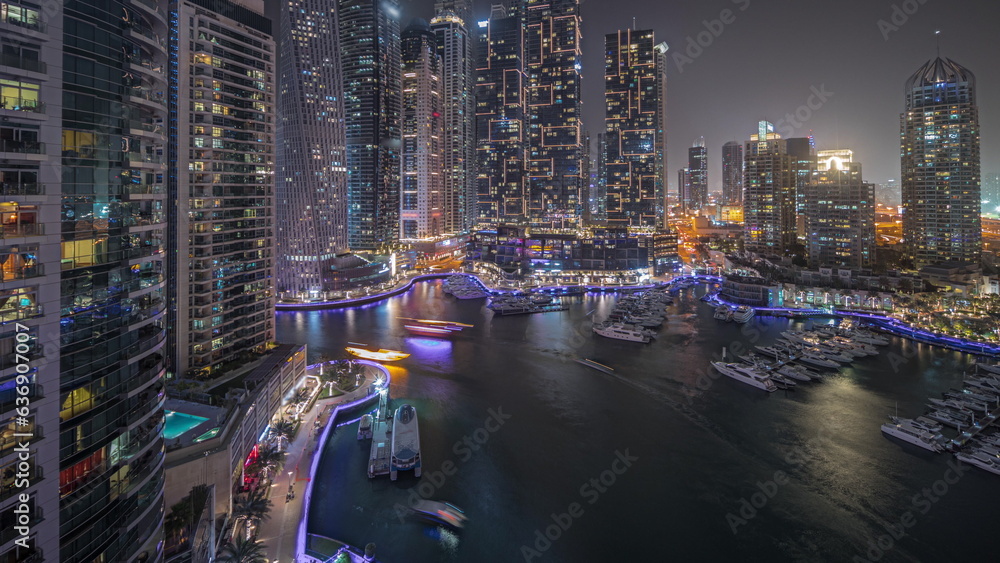 Panorama showing luxury yacht bay in the city aerial night timelapse in Dubai marina