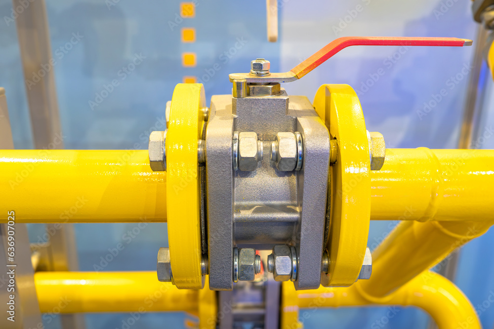 Ball valve on pipe. Yellow pipeline with flanges. Pipe connection point. Gas equipment. Ball valve for shutting off pressure in pipe. Equipment for gasification. Pipeline with flanges close-up Ball valve on pipe. Yellow pipeline with flanges. Pipe connection point. Gas equipment. Ball valve for shutting off pressure in pipe. Equipment for gasification. Pipeline with flanges close-up