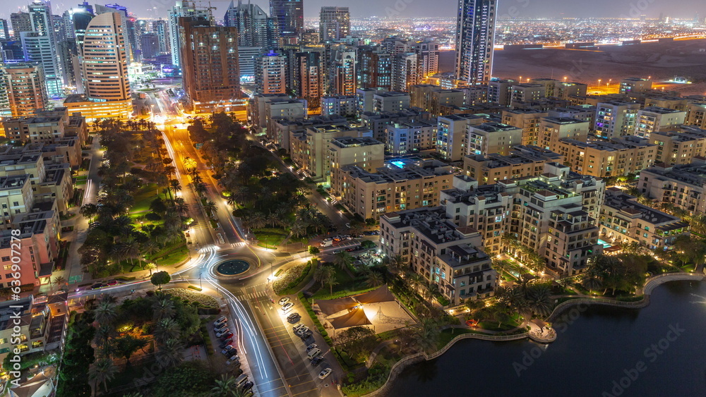 Fototapeta premium Skyscrapers in Barsha Heights district and low rise buildings in Greens district aerial day to night timelapse.