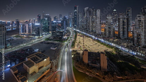 Panorama showing Bay Avenue with modern towers residential development in Business Bay aerial night timelapse, Dubai