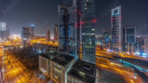 Aerial view of Dubai International Financial District with many skyscrapers all night timelapse.